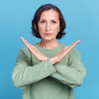 Photo of elder white hair lady show no sign expression wear green jumper isolated on blue color background