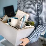 Midsection close up of unknown caucasian man holding a box with